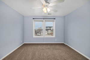 Empty room featuring ceiling fan, carpet floors, and a textured ceiling