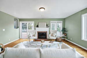 Living room featuring a brick fireplace and light wood-type flooring