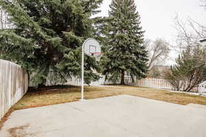 View of sport court featuring a yard