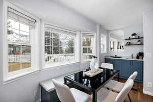 Dining area with sink and dark hardwood / wood-style flooring