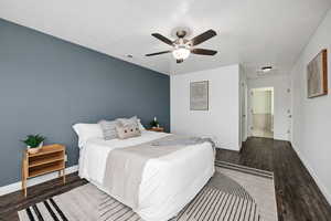 Bedroom with dark wood-type flooring and ceiling fan