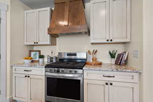 Gorgeous custom hood. Custom cabinets are off white.