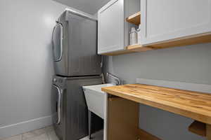 Practical laundry room on the main level, soaking sink for all those stains your family will need treating, counter space for folding clothes and cabinets to help you store your laundry supplies.