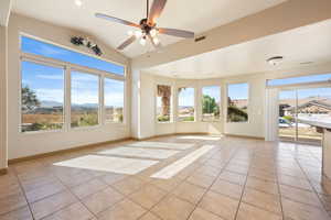 Unfurnished sunroom featuring visible vents, tile patterned floors, recessed lighting, and lofted ceiling
