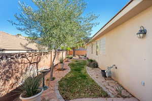 View of yard with a fenced backyard and a patio