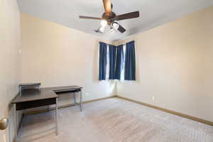 Interior space with baseboards and ceiling fan
