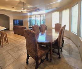 Dining room featuring light tile patterned floors and ceiling fan