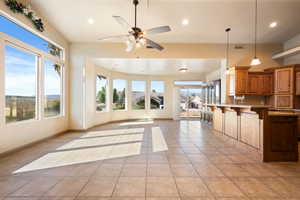 Kitchen with a wealth of natural light, open floor plan, light countertops, and light tile patterned floors