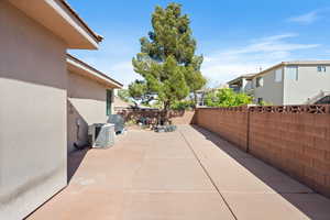 View of patio / terrace with central AC unit, a fenced backyard, and a residential view
