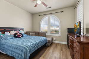 Bedroom featuring wood-type flooring and ceiling fan