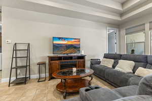 Living room featuring light tile patterned floors and a fireplace