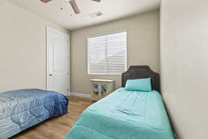 Bedroom with ceiling fan and light wood-type flooring