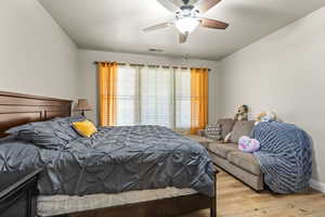 Bedroom with ceiling fan and light hardwood / wood-style flooring