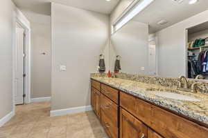 Bathroom featuring tile patterned flooring and vanity