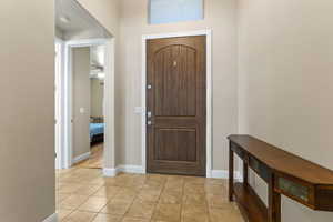 Tiled entrance foyer featuring ceiling fan