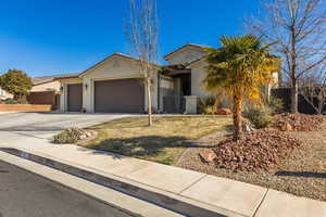 View of front facade with a garage and a front yard