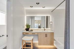 Bathroom with vanity, tile patterned flooring, and bathing tub / shower combination