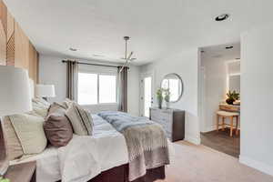 Bedroom with carpet flooring and a textured ceiling