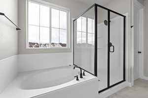 Bathroom featuring shower with separate bathtub