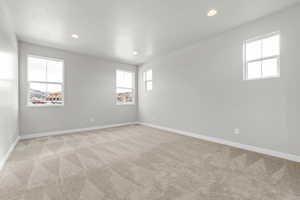 Unfurnished room with light colored carpet and a textured ceiling