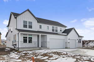 View of front of home with a garage and covered porch