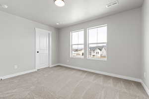 Unfurnished room with carpet floors and a textured ceiling