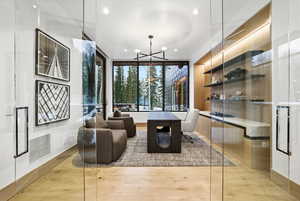 Living room with a chandelier, recessed lighting, and light wood finished floors
