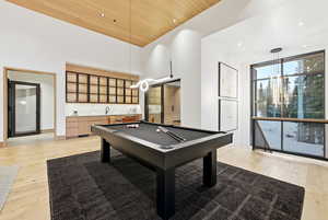 Game room featuring wooden ceiling, light wood-style flooring, recessed lighting, billiards table, and expansive windows