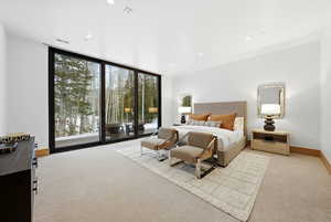 Bedroom featuring floor to ceiling windows, access to outside, light carpet, and recessed lighting