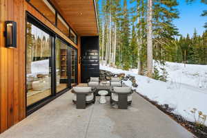 Snow covered patio featuring a patio area