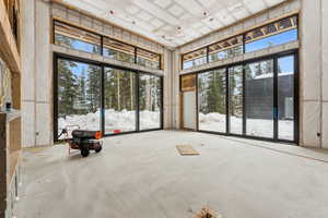 Interior space with a towering ceiling and concrete flooring