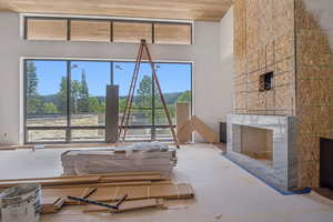 Living area with a fireplace and wood ceiling