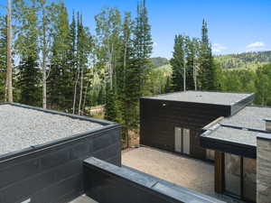 Exterior space featuring a wooded view