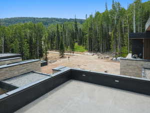 View of patio / terrace featuring a forest view