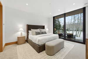 Bedroom featuring access to exterior, carpet flooring, floor to ceiling windows, and recessed lighting