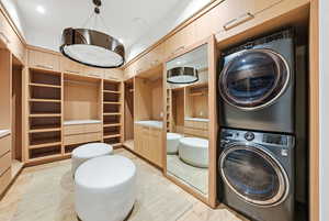 Laundry area with stacked washer and clothes dryer