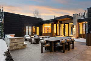 Back of property with outdoor dining area, a patio area, and outdoor lounge area