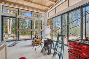 Sunroom / solarium with beam ceiling and healthy amount of natural light