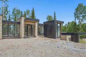 Back of house featuring concrete block siding