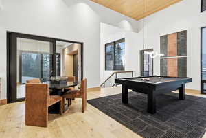 Game room featuring billiards table, a towering ceiling, wooden ceiling, light wood-style flooring, and recessed lighting