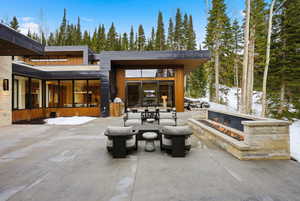 Snow covered patio with a patio area