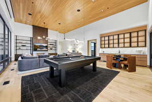 Game room with a towering ceiling, wooden ceiling, billiards table, and recessed lighting