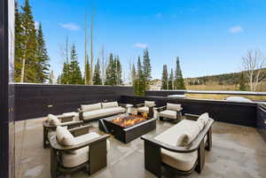 View of patio / terrace with an outdoor living space with a fire pit