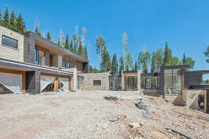 View of front of home featuring stone siding and area for grilling
