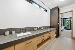 Bathroom featuring double vanity, recessed lighting, and ensuite bath