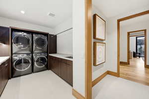 Laundry area featuring cabinet space and light flooring