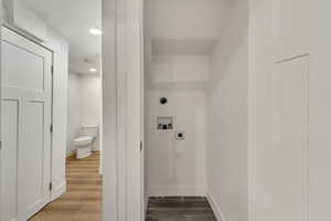 Laundry area with washer hookup, hookup for an electric dryer, and light wood-type flooring