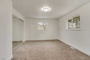 Unfurnished bedroom with a closet and carpet