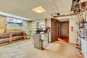 Basement featuring a workshop area and a drop ceiling