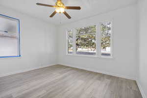 Empty room featuring ceiling fan and light hardwood / wood-style flooring